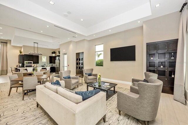 6249 Mesa Gln, Bradenton, FL 34203 - living room featuring a tray ceiling, recessed lighting, and baseboards