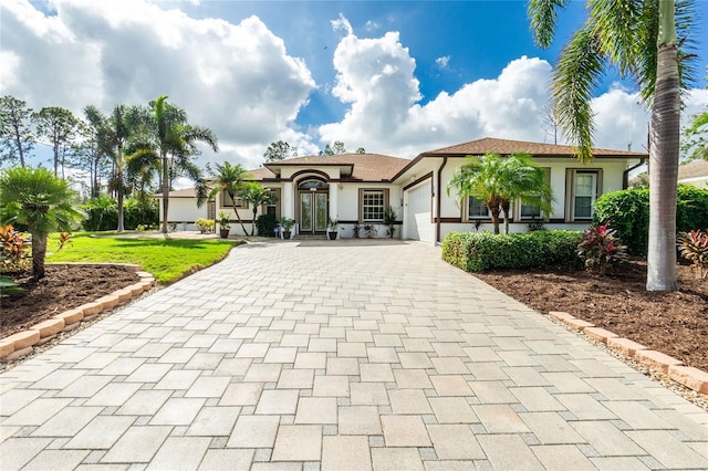 view of front of property featuring a garage and a front lawn