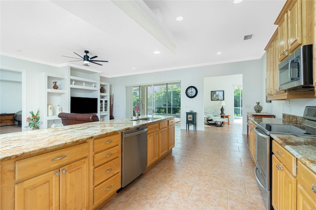 kitchen featuring sink, built in shelves, stainless steel appliances, and light stone countertops