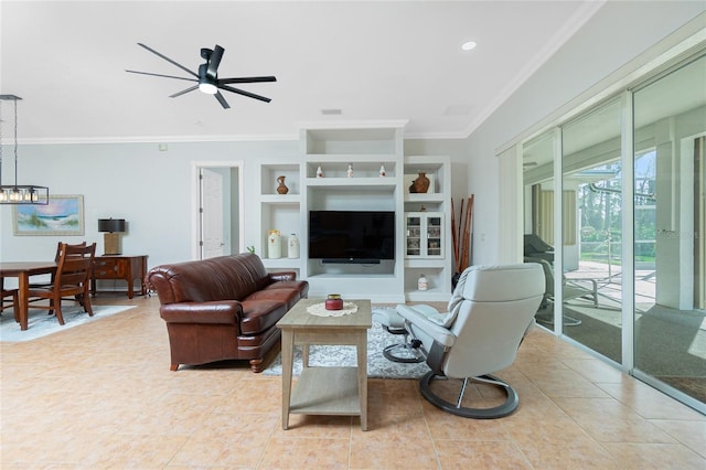 living room with built in shelves, ceiling fan with notable chandelier, ornamental molding, and light tile patterned flooring