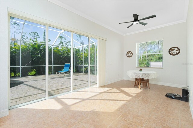 interior space featuring crown molding, ceiling fan, and tile patterned floors