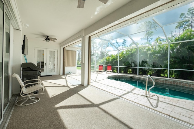 view of swimming pool with a patio, a lanai, ceiling fan, and french doors