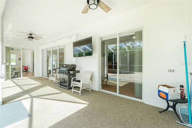 sunroom / solarium featuring ceiling fan