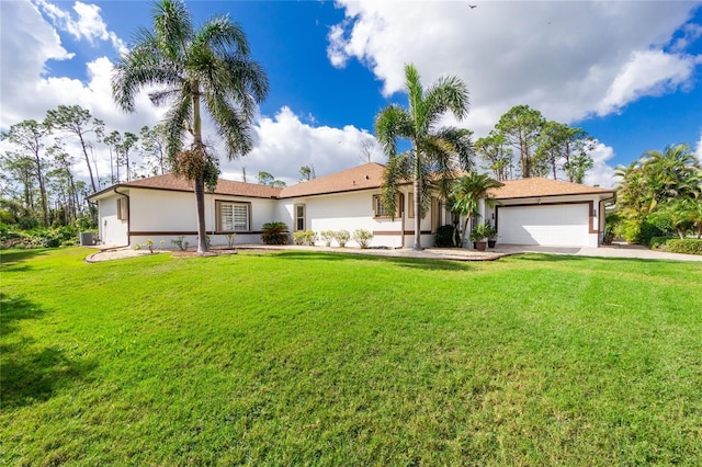 view of front of home with a garage and a front lawn