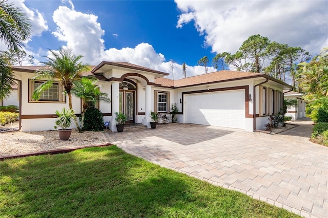 view of front facade with a garage and a front yard