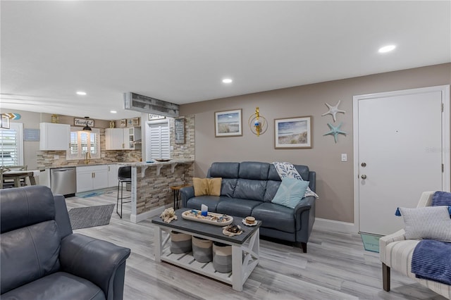 living room featuring light hardwood / wood-style flooring and sink