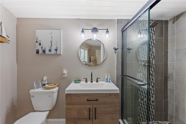 bathroom featuring walk in shower, vanity, and toilet