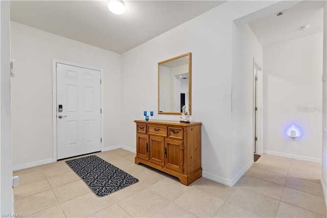 foyer entrance featuring light tile patterned floors