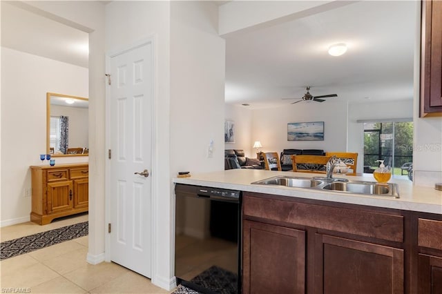 kitchen with dark brown cabinetry, light tile patterned flooring, sink, ceiling fan, and black dishwasher