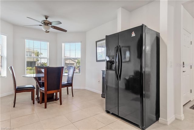 dining area with light tile patterned flooring and ceiling fan