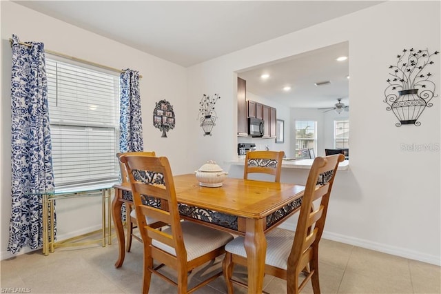 tiled dining room featuring ceiling fan