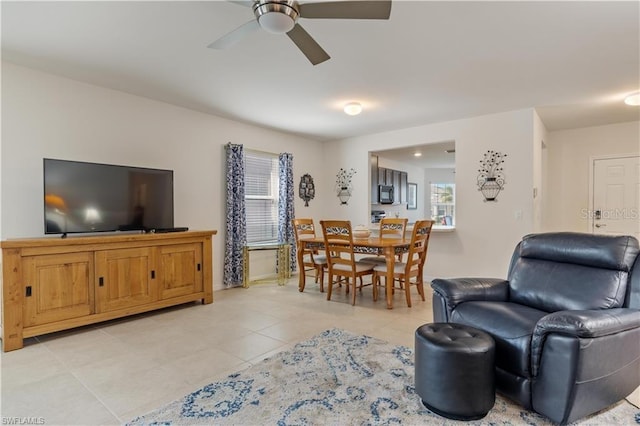 living room featuring light tile patterned flooring and ceiling fan