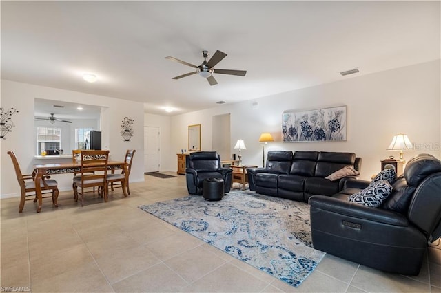 tiled living room featuring ceiling fan