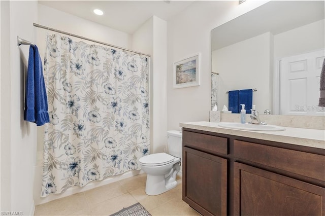 bathroom featuring toilet, vanity, and tile patterned flooring