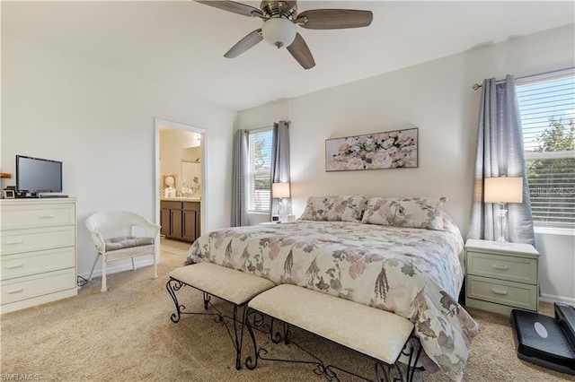 carpeted bedroom with ceiling fan and ensuite bathroom