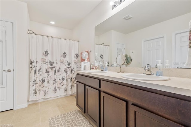 bathroom with vanity, tile patterned floors, and curtained shower