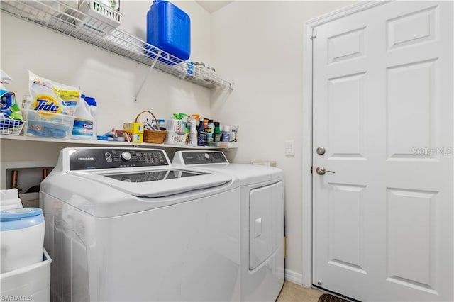 clothes washing area with separate washer and dryer