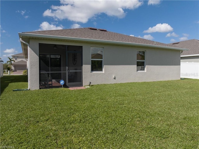 rear view of property with a lawn