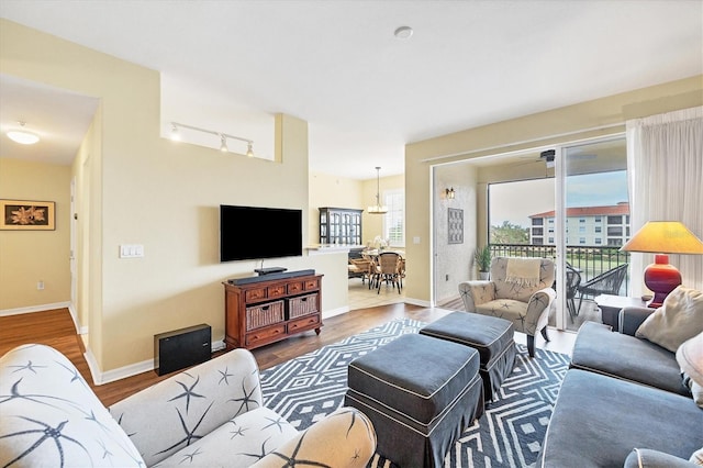 living room featuring ceiling fan and hardwood / wood-style floors