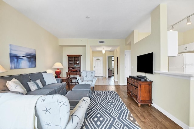 980 Cooper St Unit 302, Venice, FL 34285 - living area featuring rail lighting and wood finished floors