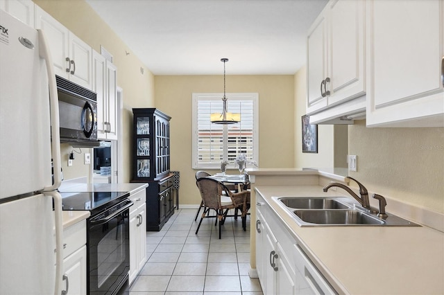 kitchen with sink, white cabinets, decorative light fixtures, light tile patterned floors, and black appliances