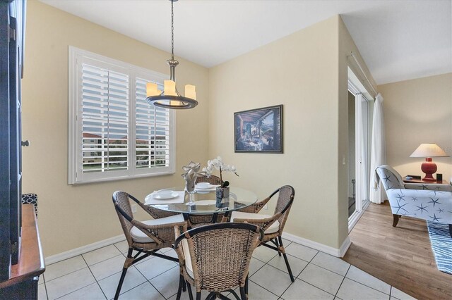 980 Cooper St Unit 302, Venice, FL 34285 - dining area featuring tile patterned flooring and a chandelier