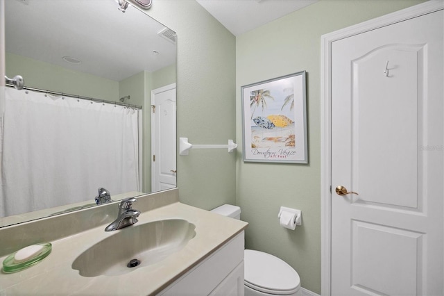 bathroom with toilet and vanity