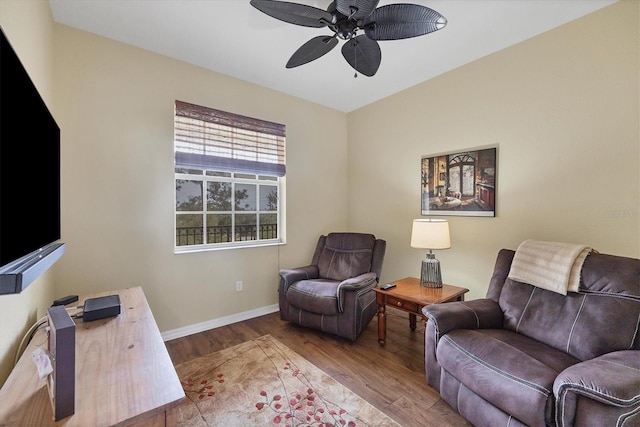 living area with ceiling fan and light hardwood / wood-style floors