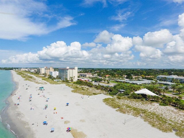 birds eye view of property with a view of the beach and a water view