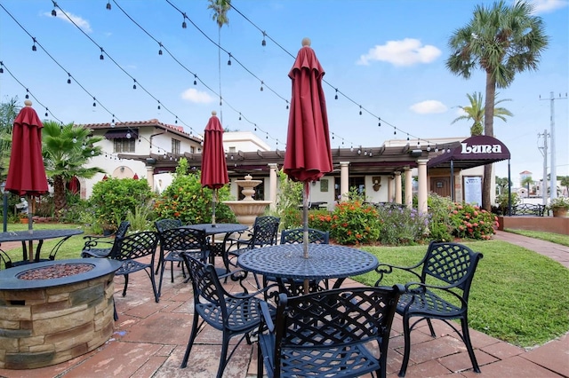 view of patio / terrace with a fire pit and a pergola