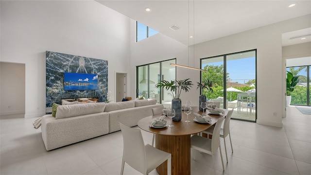 tiled dining area with a high ceiling