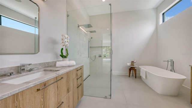 bathroom featuring shower with separate bathtub, vanity, and tile patterned floors