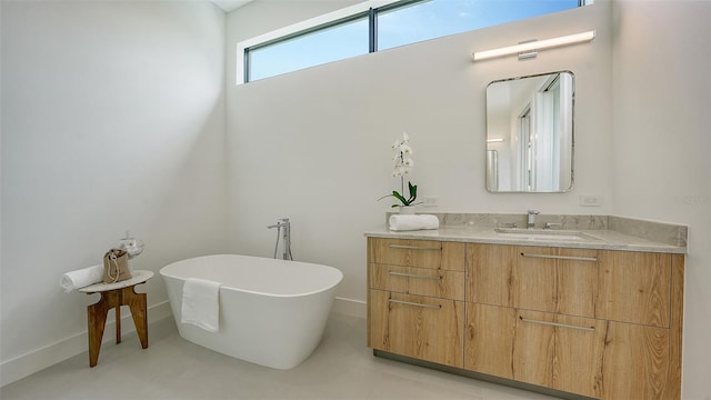 bathroom featuring vanity and a tub to relax in