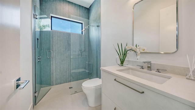 bathroom with tile patterned floors, a shower with door, vanity, and toilet