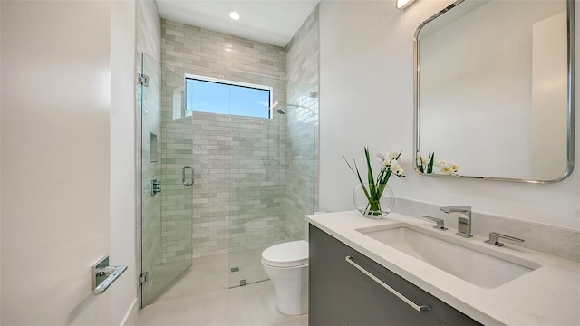 bathroom with tile patterned flooring, vanity, toilet, and a shower with shower door