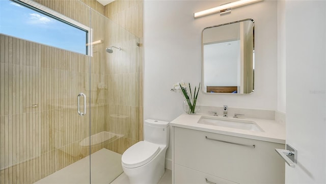 bathroom featuring vanity, toilet, and walk in shower