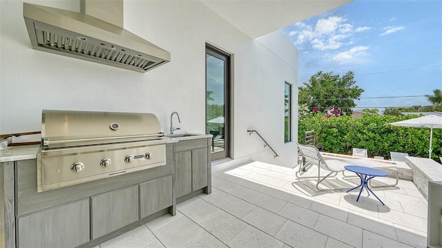 view of patio featuring area for grilling, exterior kitchen, and sink