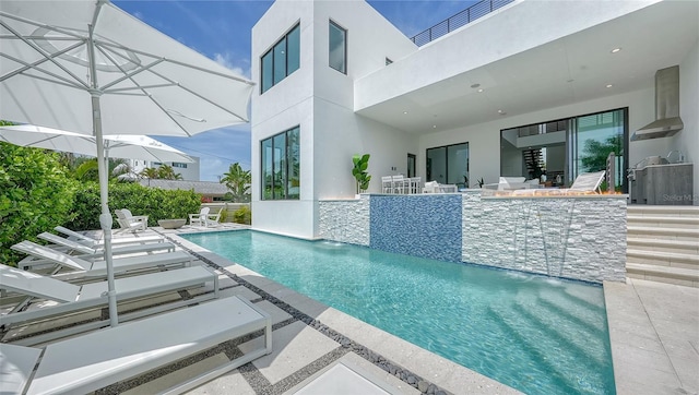 view of pool with pool water feature and a patio area