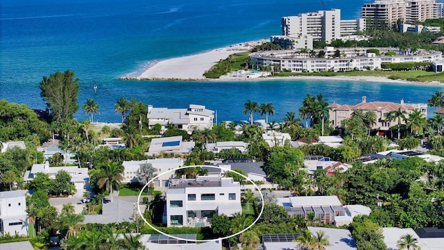 birds eye view of property featuring a water view and a view of the beach