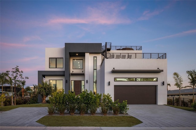 contemporary home featuring a garage and a balcony