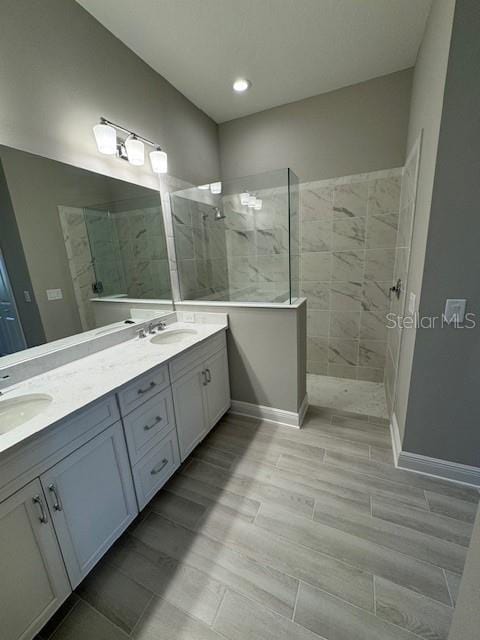 bathroom featuring vanity and a tile shower