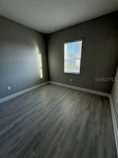 spare room with wood-type flooring