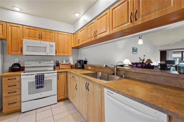 kitchen featuring lofted ceiling, sink, light tile patterned flooring, and white appliances