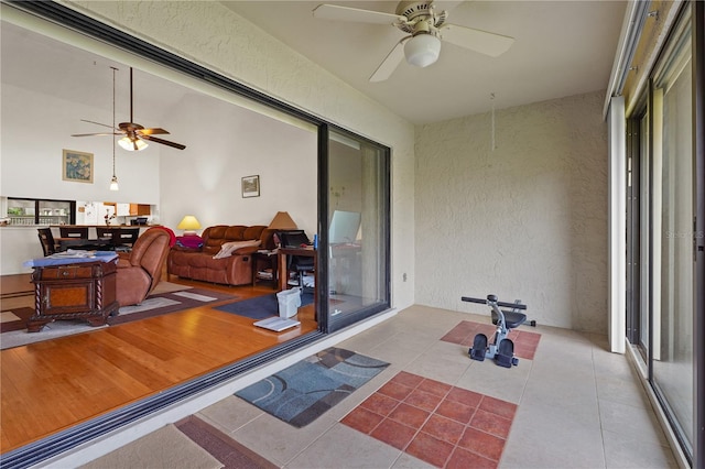 sunroom / solarium featuring ceiling fan and lofted ceiling