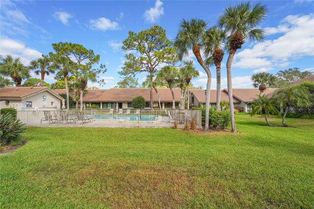 view of yard with a fenced in pool