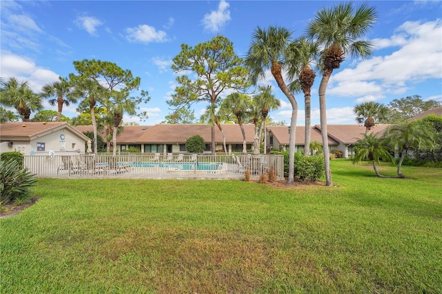 view of yard with fence and a community pool