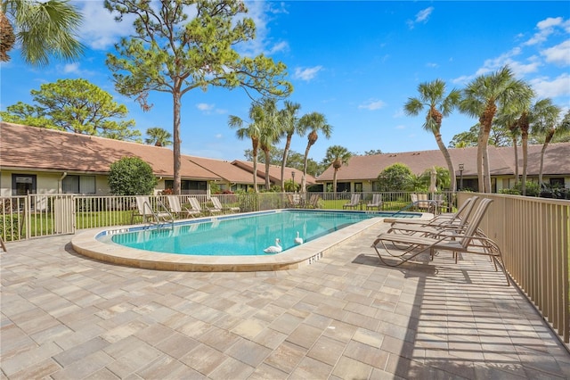 pool with fence and a patio