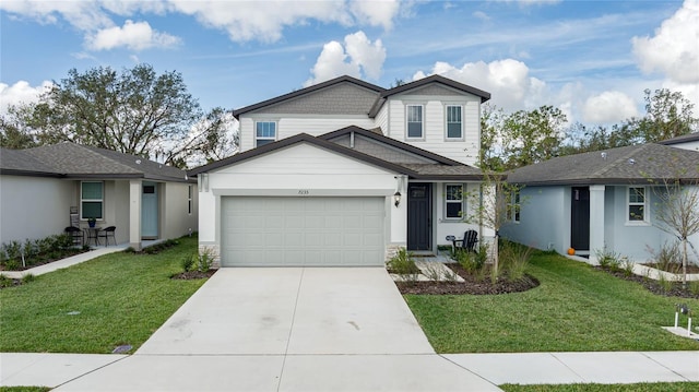 view of front of property with a front yard and a garage