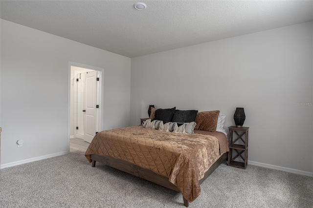 bedroom with a textured ceiling and carpet flooring