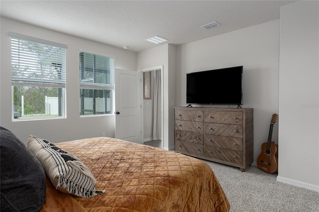 bedroom with a textured ceiling and carpet